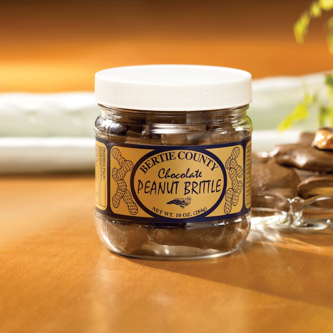 A jar of Bertie County Chocolate Peanut Brittle