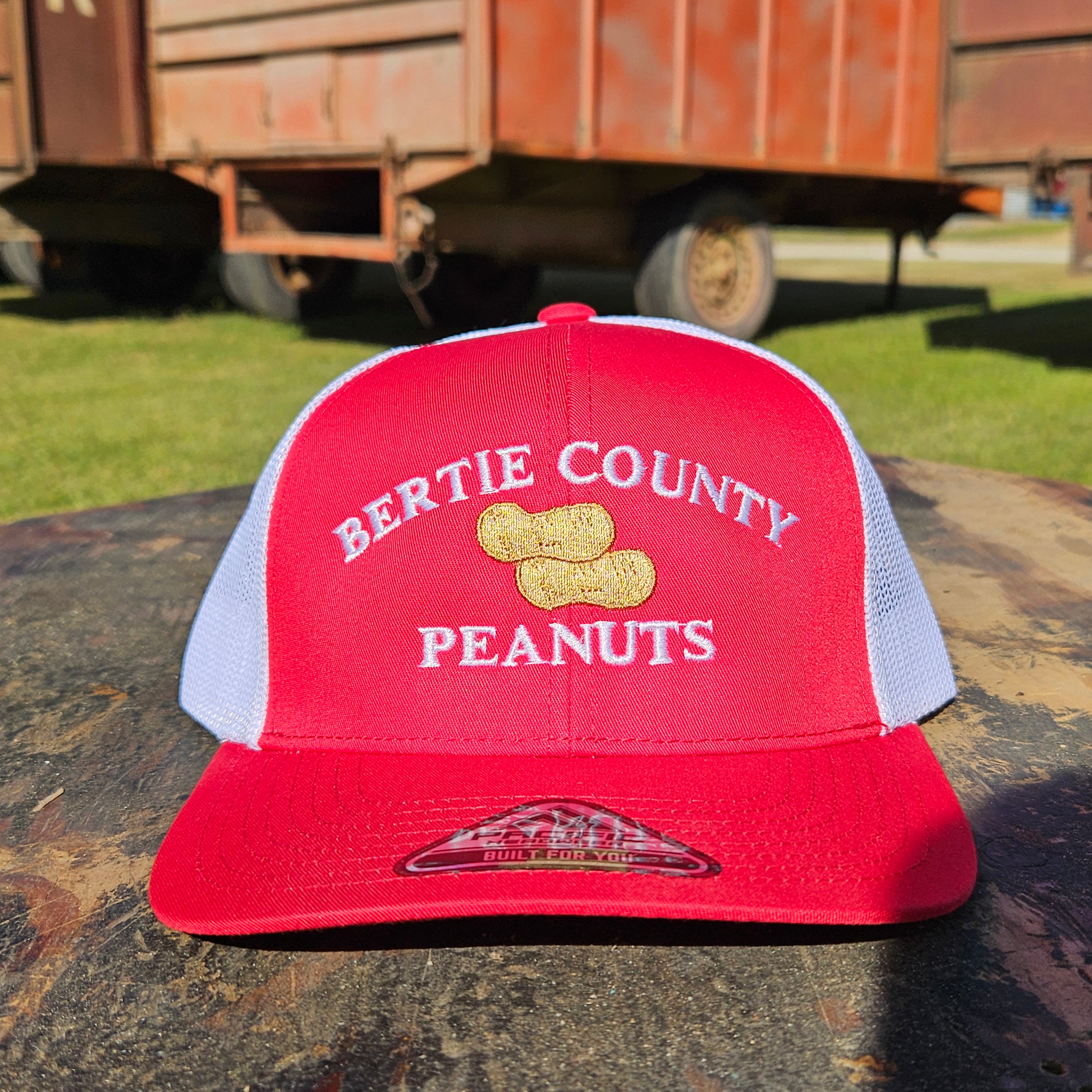 A red and white hat with Bertie County Peanuts branding
